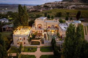 an aerial view of a large mansion with lights at IL Castello Boutique Hotel in Clarens