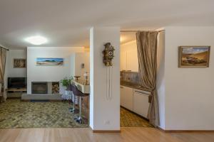 a kitchen and a living room with a table at Edelweiss in Charmey