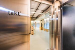 an office hallway with a take sign on the wall at Takt Jongno Female Only Capsule Hotel in Seoul