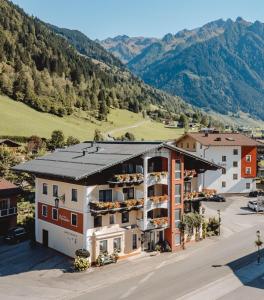 an aerial view of a building with mountains in the background at Apart-Pension Oberreiter in Fusch an der Glocknerstraße