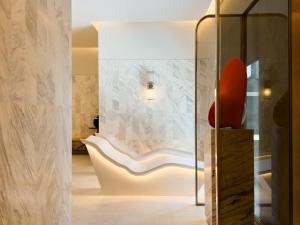 a room with a white chair and a glass door at Andaz One Bangkok, by Hyatt in Bangkok +213 photos