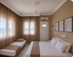 a bedroom with two beds and a window at Basilio's Studios in Leptokarya