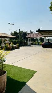 a parking lot with a gas station at บ้านประภัสราคม โฮมสเตย์ นครสวรรค์ in Ban Ko Ta Thep