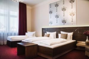 a hotel room with two beds and a window at Hotel Prinzregent in Nuremberg