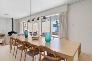 a dining room with a wooden table and chairs at Viana Vista Villa in Viana do Castelo