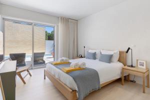 a bedroom with a large bed with towels on it at Viana Vista Villa in Viana do Castelo +22 photos