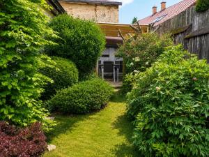 a garden with bushes and a table and chairs at Seč Aktivně in Seč