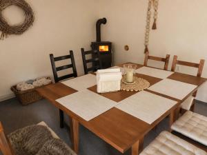 a dining room with a table and a wood stove at Seč Aktivně in Seč