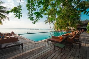 a resort with a pool and chairs and the ocean at Hotel Anmol&Rooms in Gothaj