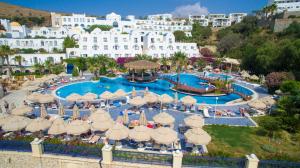 an aerial view of a resort pool with umbrellas at Salmakis Resort & Spa in Bodrum City