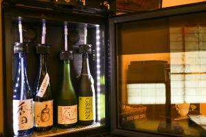 a group of wine bottles in a refrigerator at Hotel Alza Kyoto in Kyoto +29 photos