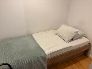 a bed with white sheets and pillows on it at Apartament za ratuszem in Tarnowskie Góry +12 photos