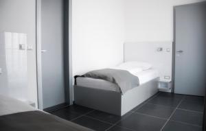Postel nebo postele na pokoji v ubytování Whitehouse Apartments
