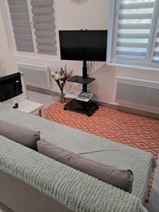 a bedroom with a bed and a flat screen tv at Aulta in Ault