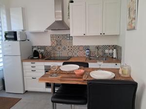 a kitchen with a wooden table and white cabinets at Aulta in Ault
