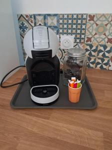 a black and white coffee maker on a tray at Aulta in Ault