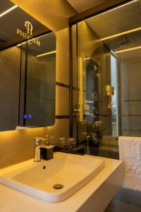 a bathroom with a white sink and a mirror at khách sạn phúc hải in Da Lat