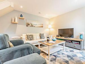 a living room with two couches and a tv at 1 Bed in Dronfield oc-40971 in Chesterfield