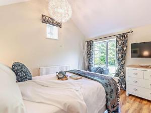 a bedroom with a bed and a tv and a window at 1 Bed in Dronfield oc-40971 in Chesterfield