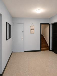 an empty room with a door and a staircase at Onyx Green in Saint-Aignan +2 photos