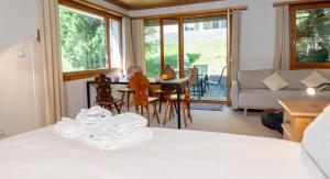 a bedroom with a bed and a table and chairs at Garden apartment with mountain views & barbecue in Lenz