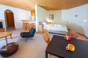 a bedroom with a bed and a table and chairs at Garden apartment with mountain views & barbecue in Lenz