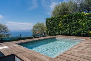 a swimming pool on top of a wooden deck at casa FraLu in Vico Equense