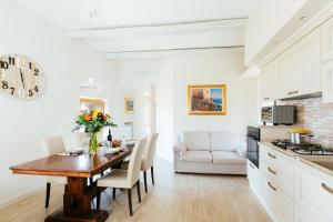 a kitchen and dining room with a table and chairs at casa FraLu in Vico Equense
