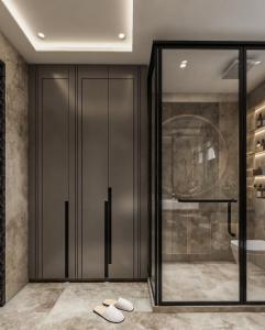 a bathroom with a glass door with two slippers at Hotel The New Pacific Suites Near IGI Airport Delhi in New Delhi