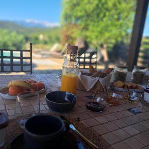 a table with food and a bottle of orange juice at Mas del Sola in Castelnou