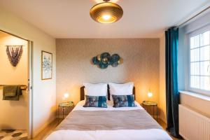 a bedroom with a large bed with two pillows at AGAP' & MORPHEE in Pouancé
