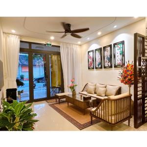 a living room with a couch and a ceiling fan at HueS Home in Hue