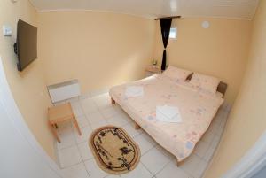a small bedroom with a bed and a chair at Aurum Etno & Spa in Smederevo +46 photos