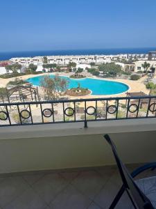 a balcony with a view of a swimming pool at Sea View Pool 2BR Esentepe in Kalogrea
