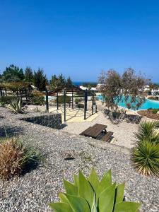 a park with plants and a playground with water at Sea View Pool 2BR Esentepe in Kalogrea