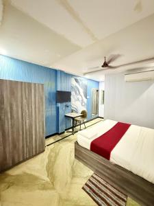 a bedroom with a bed and a table in it at Amba palace in Prayagraj