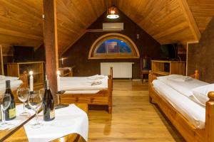 a room with two beds and a table with wine glasses at Krakowiacy i Górale in Krzyszkowice +27 photos