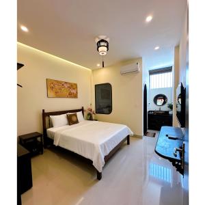 a bedroom with a large white bed in a room at HueS Home in Hue