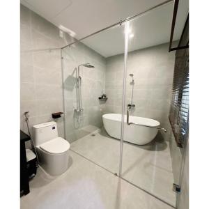 a bathroom with a tub and a toilet and a shower at HueS Home in Hue +13 photos