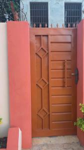 a large wooden gate with a brown door at Elite Solutions Apartments in Ouéga