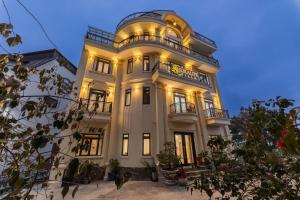 a large white building with lights on at AuraLite Hotel - Panorama View Đà Lạt in Da Lat