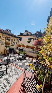 a patio with benches and plants on a building at Foresteria di Palazzo Picedi - Historic Rooms Sarzana in Sarzana
