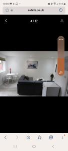a living room with a couch and a table at COMFY GUEST suite in Dartford +8 photos