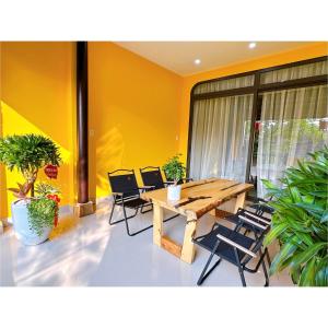 a dining room with a wooden table and chairs at HueS Home in Hue