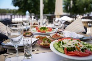 a table with plates of food and glasses of water at Quatro Life Hotel in Bodrum City