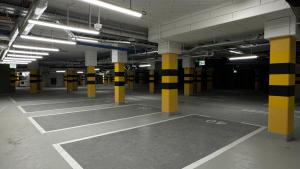 an empty parking lot with yellow and black columns at Première Classe Warsaw Airport in Warsaw