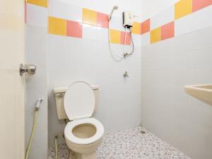 a bathroom with a toilet and a phone on the wall at โรงแรม วี เฮาส์ ณ คอน in Nakhon Si Thammarat +52 photos