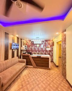 a living room with a couch and a tv at Amba palace in Prayagraj