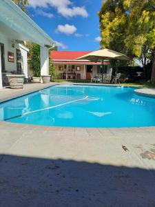 a swimming pool in front of a house at Meerlin Guest House in Queenstown