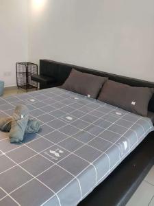 a bed with a teddy bear on top of it at Metropol Summer Cozy Suite in Bukit Mertajam +43 photos